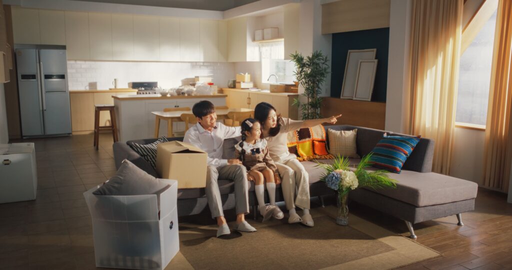 a family of three bonding on their living room