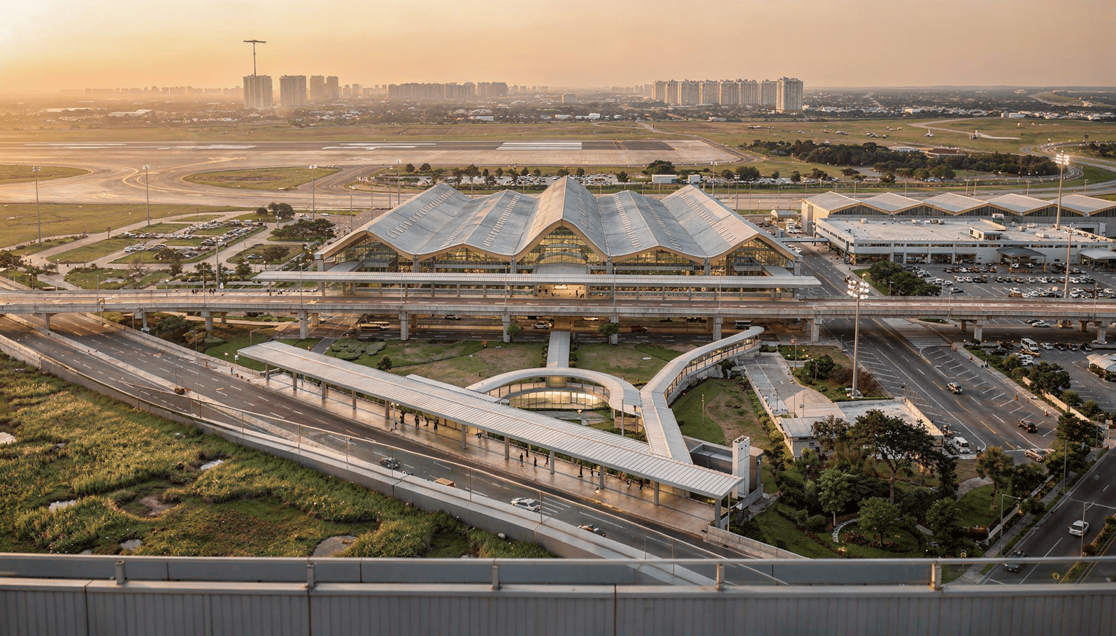 Clark International Airport within the aerotropolis plan, featuring modern terminal design and integrated transport systems at sunset