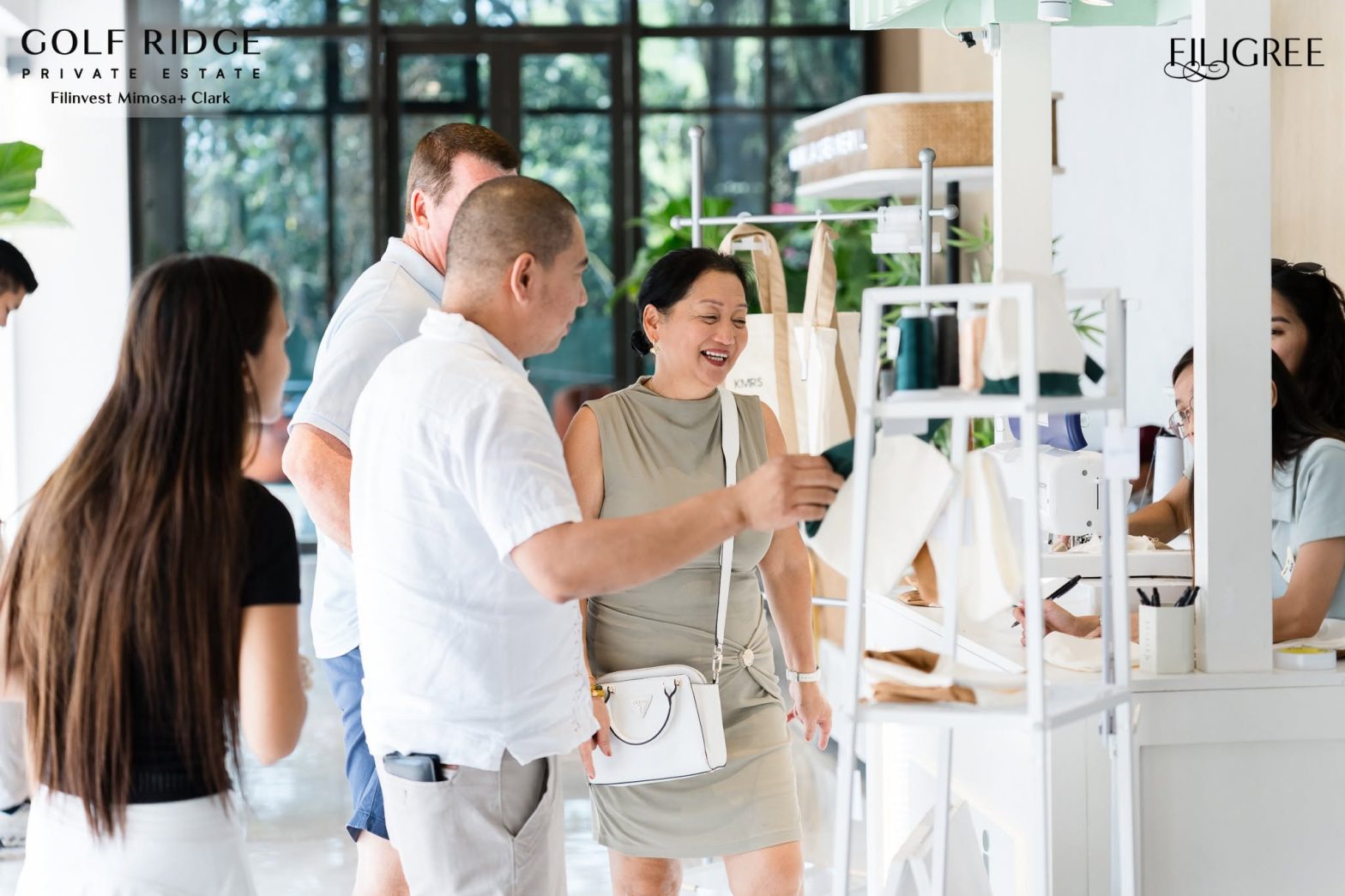 A group of people interacting with an indoor retail display booth.